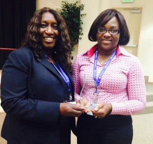 Fadeke Ogunyankin (right) receives her award at JPS Research Day in 2014.